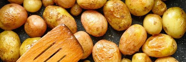 Golden roasted potatoes in the skin photo