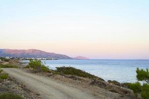 Seascape at dusk with background mountains photo