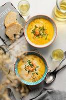 Homemade Finnish salmon soup with cream served with white wine photo
