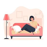 Young woman sitting at home on the sofa and reading a book vector
