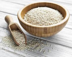 Sesame seeds in a bowl on a rustic table photo