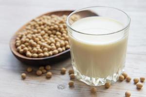 Soy milk and soy on a wooden table photo