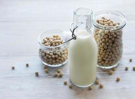 Soy milk and soy on a wooden table photo