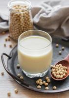 Soy milk and soy on a wooden table photo