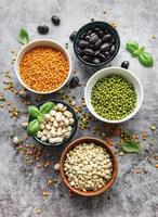 Bowls with different types of legumes photo