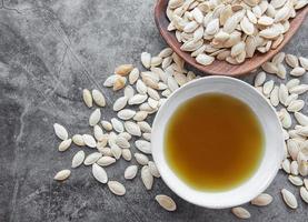 Bowl with pumpkin seed oil photo