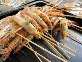 Skewered prawns ready for barbecue photo