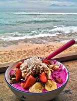 A bowl of pitaya by the beach photo