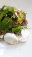 Eggs and avocado toast on a white plate photo