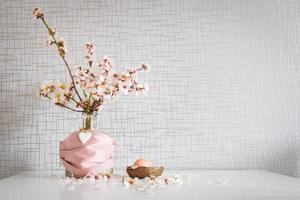 Spring daisy flowers with pink facial mask covering an Easter egg photo