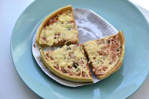 Cheap little pizza with cheese close-up on a plate photo