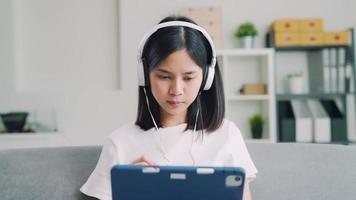 Woman Wearing Headphones on Tablet video