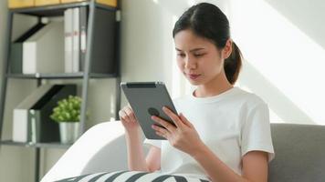 Woman On Couch Using Digital Tablet video