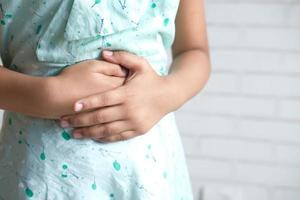 Child suffering stomach pain close up photo