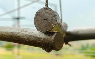Small wooden logs held up by rope photo