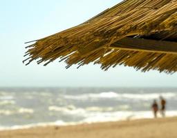 Beach umbrella with people in the background photo