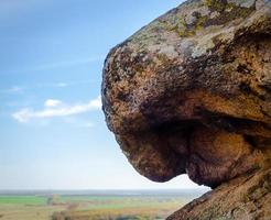 Stone rock against blue sky photo