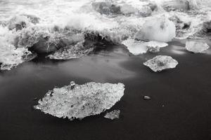 Ice on black beach in Vik, Iceland photo