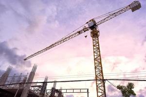 Yellow construction tower crane photo