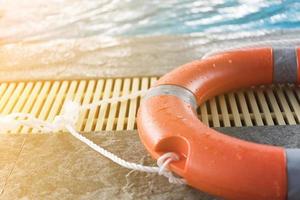 Orange floatation device by a swimming pool photo