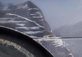 Scratches on the body of a gray car from an auto accident photo