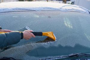 Swiping ice off a windshield photo