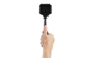 Hand holding an action camera on a stabilizer