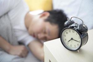 Sleeping man with alarm clock