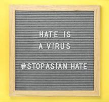 Letterboard with quote Hate is a Virus and hashtag Stop Asian Hate photo