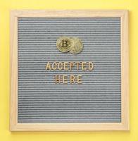 Golden virtual money Bitcoin coin with frame and text Bitcoin Accepted Here. Concept of bitcoin payment, shopping or purchase and cryptocurrency accepted photo
