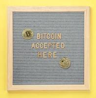 Golden virtual money Bitcoin coin with frame and text Bitcoin Accepted Here. Concept of bitcoin payment, shopping or purchase and cryptocurrency accepted photo