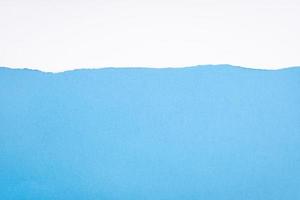 Ripped white paper on blue cardboard. Abstract paper background to add text or images. Copy space template photo