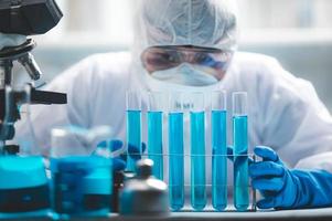 Scientist analyzing test tubes photo