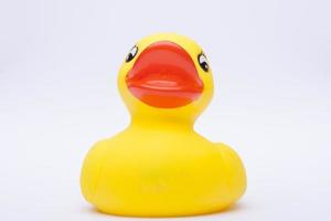 Yellow rubber duck for a kid's bath time, isolated on white background photo