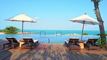 Umbrella and Chair Around Swimming Pool in Hotel Resort video