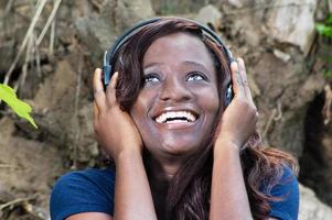 Happy young woman listening to good music with headphones