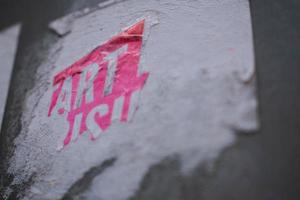 Ripped pink stinker on a concrete wall photo