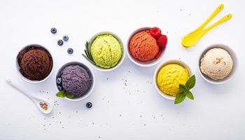 Various ice cream flavor balls on a white wooden background. Summer and sweets menu concept. photo