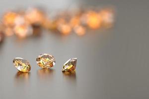 Round diamond topaz gems reflected on glossy background, 3D render
