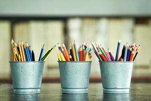 Close-up of blunted colored pencils in metal buckets photo
