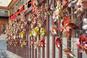 Abstract background blurred picture of motion paper mills hanging on the steel fence in Chinese temple photo