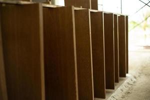 Selective focus on wooden laminated board at the factory waiting for installation photo