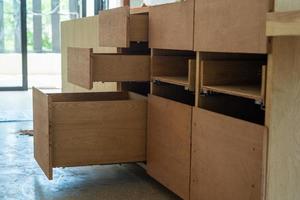 Opening wooden shelfs under installation inside the house under construction photo