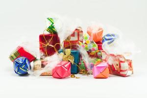 Closeup pile of  gift boxes wrapped by colorful paper for Christmas festival with isolated background. Selective focus of presents in beautiful package for giving in any occasion. photo