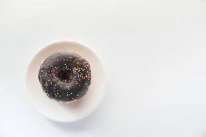 Chocolate donuts on plate with copy space photo