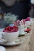 Teacups and flowers in a row photo