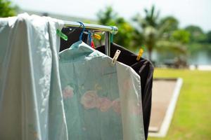 Closeup of many pieces of rags hanging with clothespin for drying by the sunlight photo