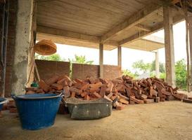 Pile of red brick stand by for installing to the wall photo