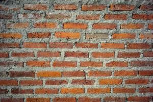 Abstract texture and background of red brick and bricklayer concrete wall photo