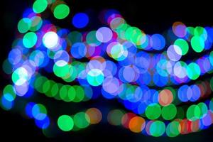 Abstract colorful bokeh lights on black background photo